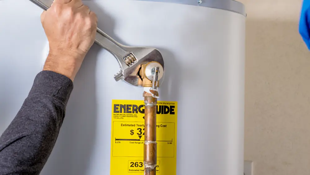 A plumber repairing a water heater in a residence.